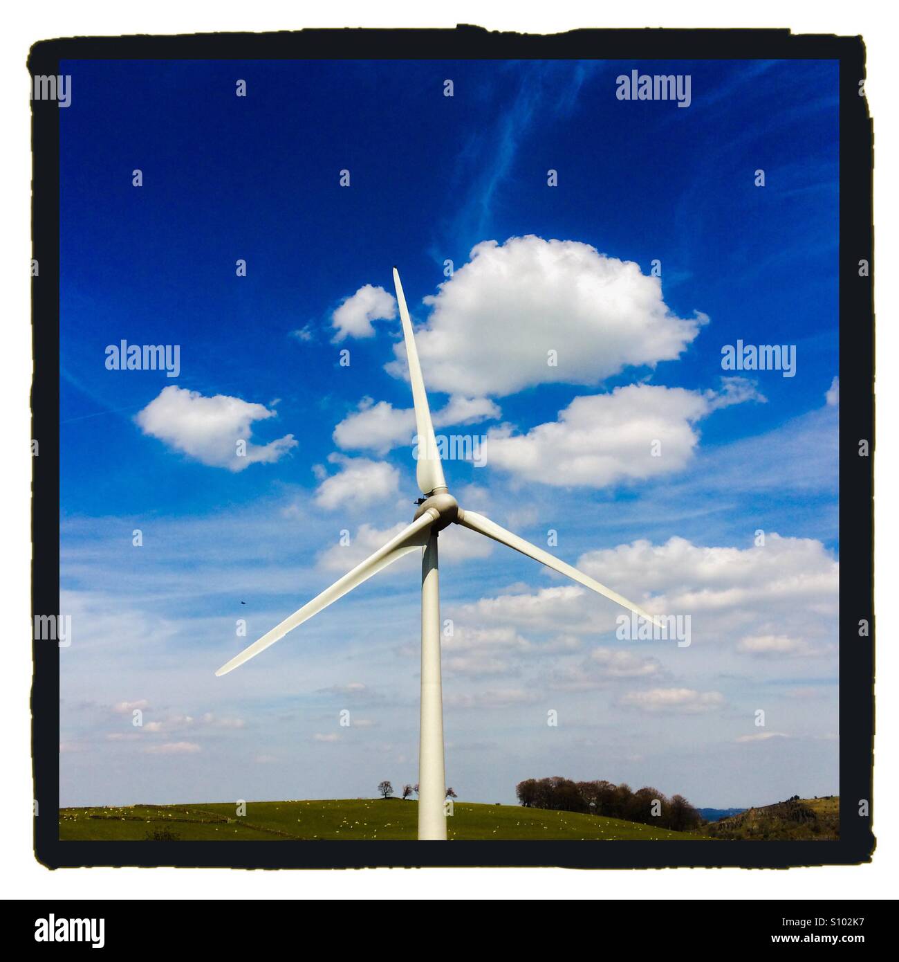 Wind turbine with blue sky behind Stock Photo - Alamy