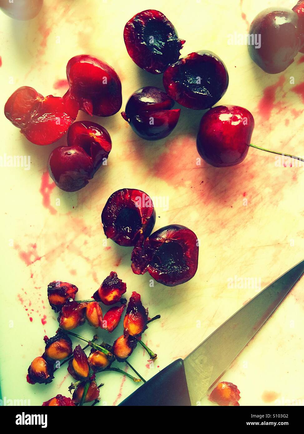 Removing pits from cherries - Smartphone Captured Stock Image