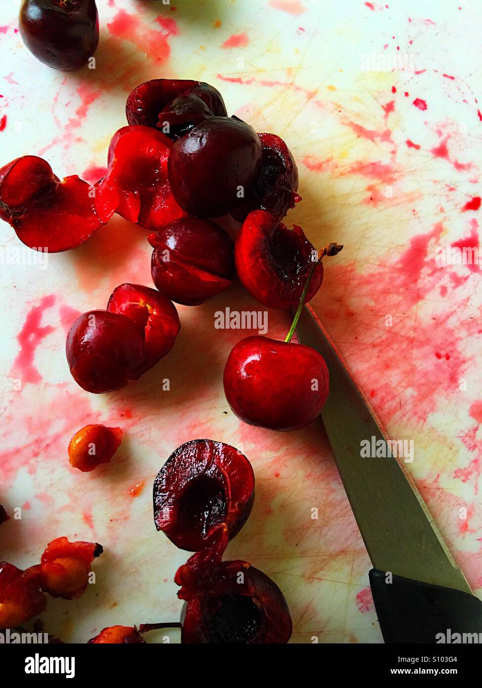 Pitting sweet cherries Stock Photo