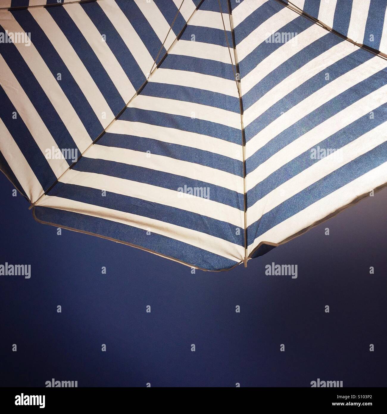 Half of an umbrella shading the sun. Stock Photo