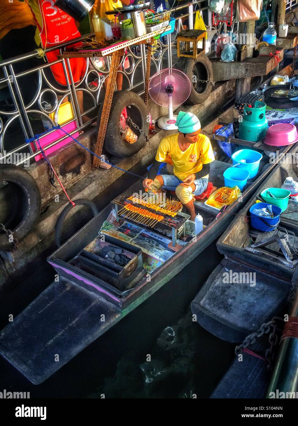 Food being prepared on a boat at the Taling Chan floating market, Bangkok, Thailand - Smartphone Captured Stock Image