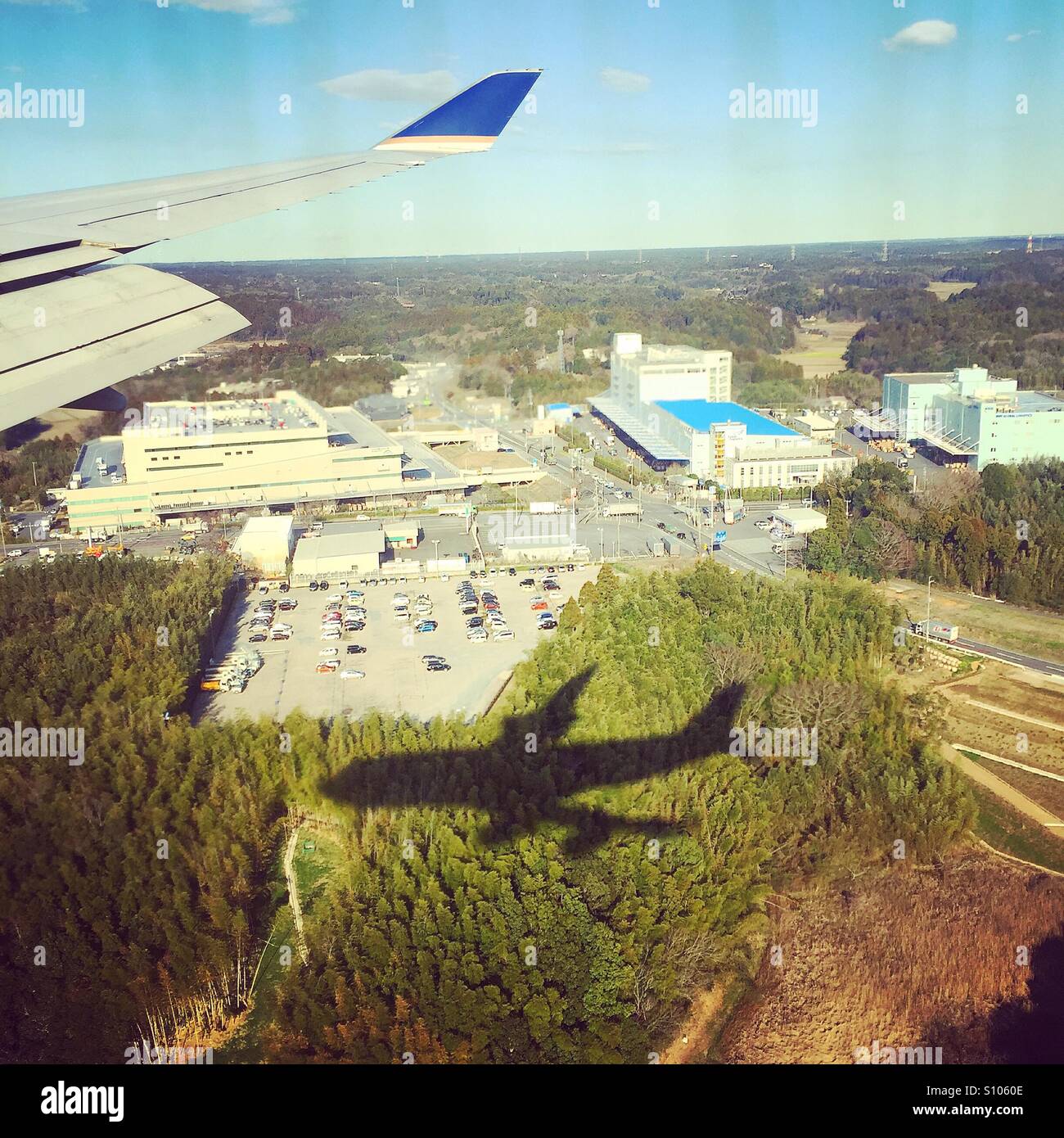 Shadow of a plane cast on the ground, photographed through the plane