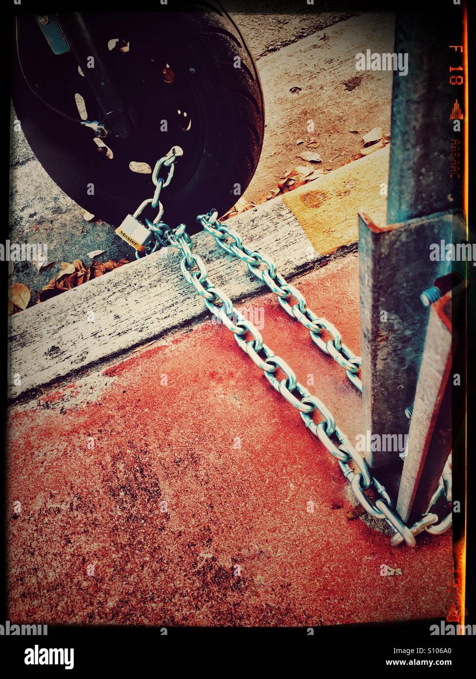 Chained motor scooter - Smartphone Captured Stock Image