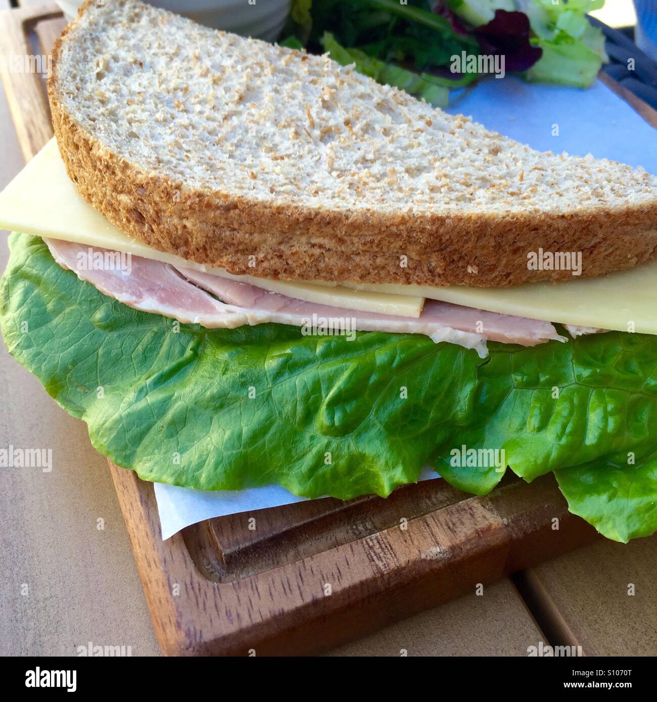 Ham cheese and salad sandwich served on brown bread Stock Photo Alamy