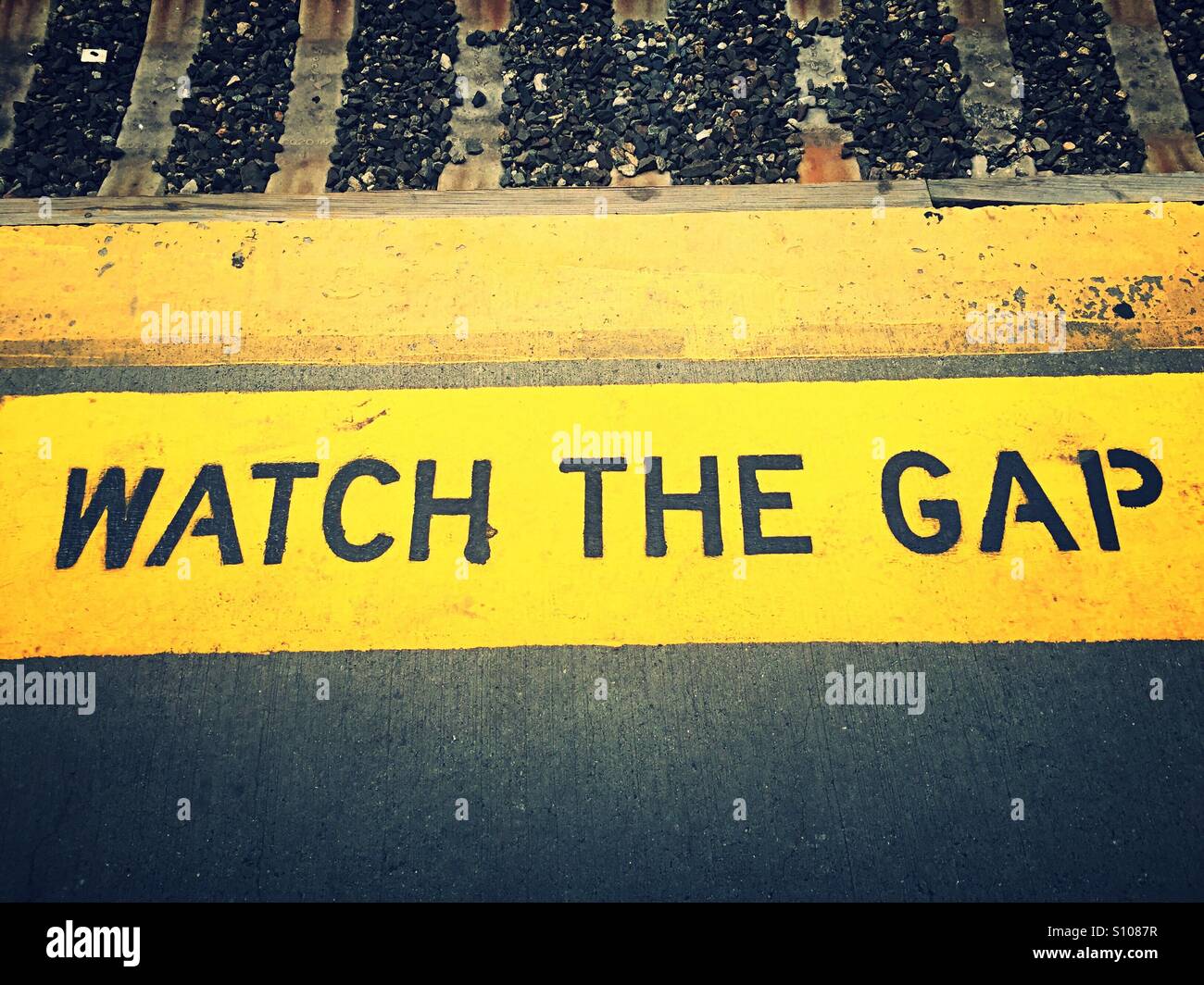 Train platform warning to watch that gap between the subway train and platform - Smartphone Captured Stock Image