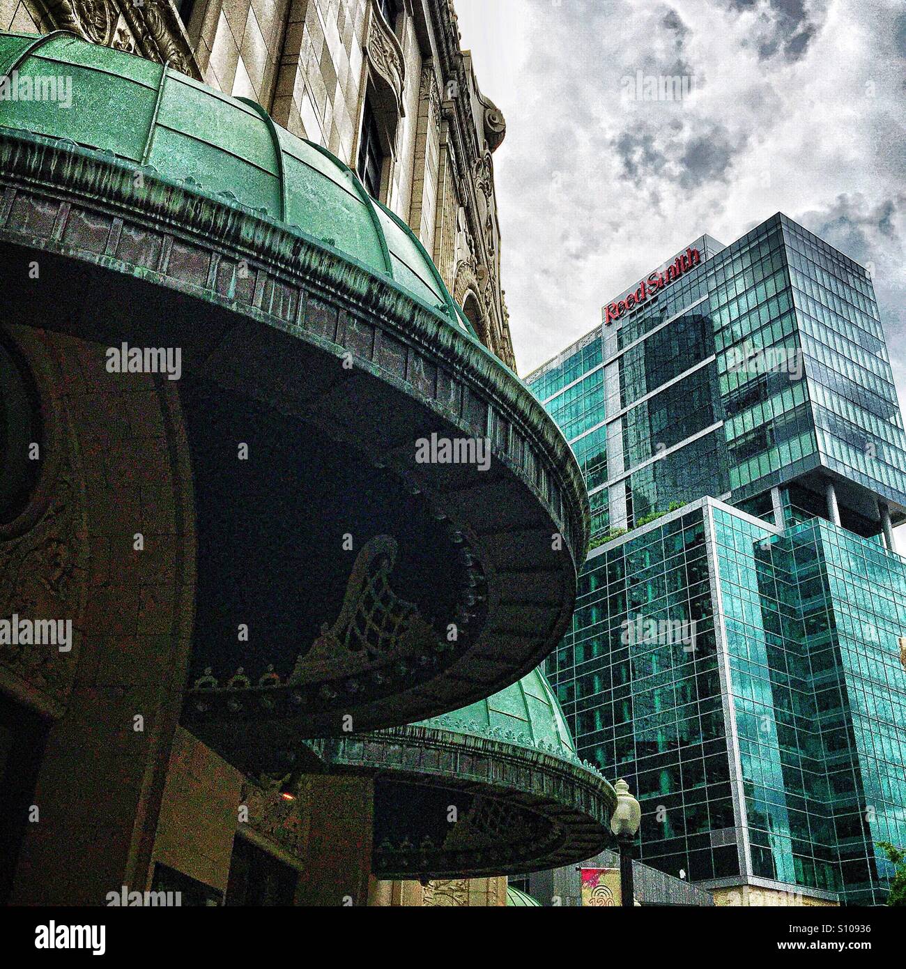 Classical green domes on the exterior of an old building contrast with the modern green glass of of a modern office building in downtown Pittsburgh, Pennsylvania. - Smartphone Captured Stock Image