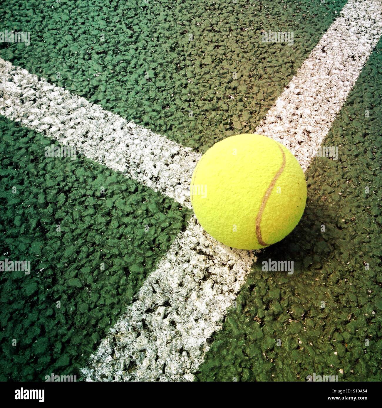 Tennis ball on a tennis court line Stock Photo