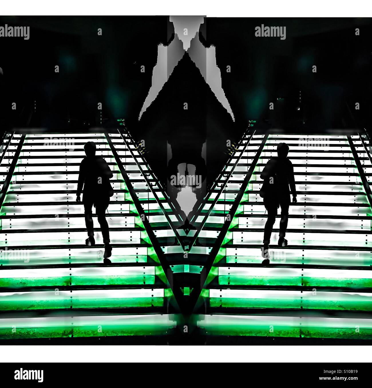 Separate ways. Two persons ascending a set of stairs on a divergent trajectory. Go left. Go right. 11 a.m. 1p.m. Never the twain shall meet. - Smartphone Captured Stock Image