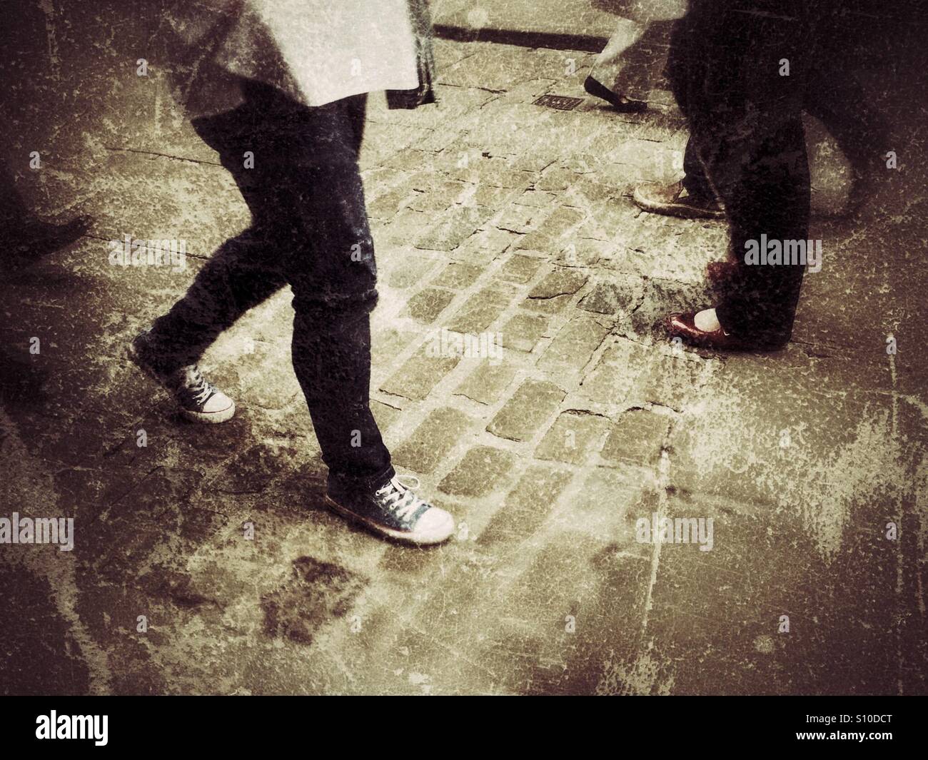 People walking along cobbled street England UK - Smartphone Captured Stock Image