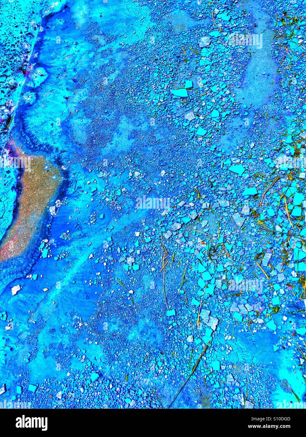 Blue paint spilled and dried on pavement Stock Photo