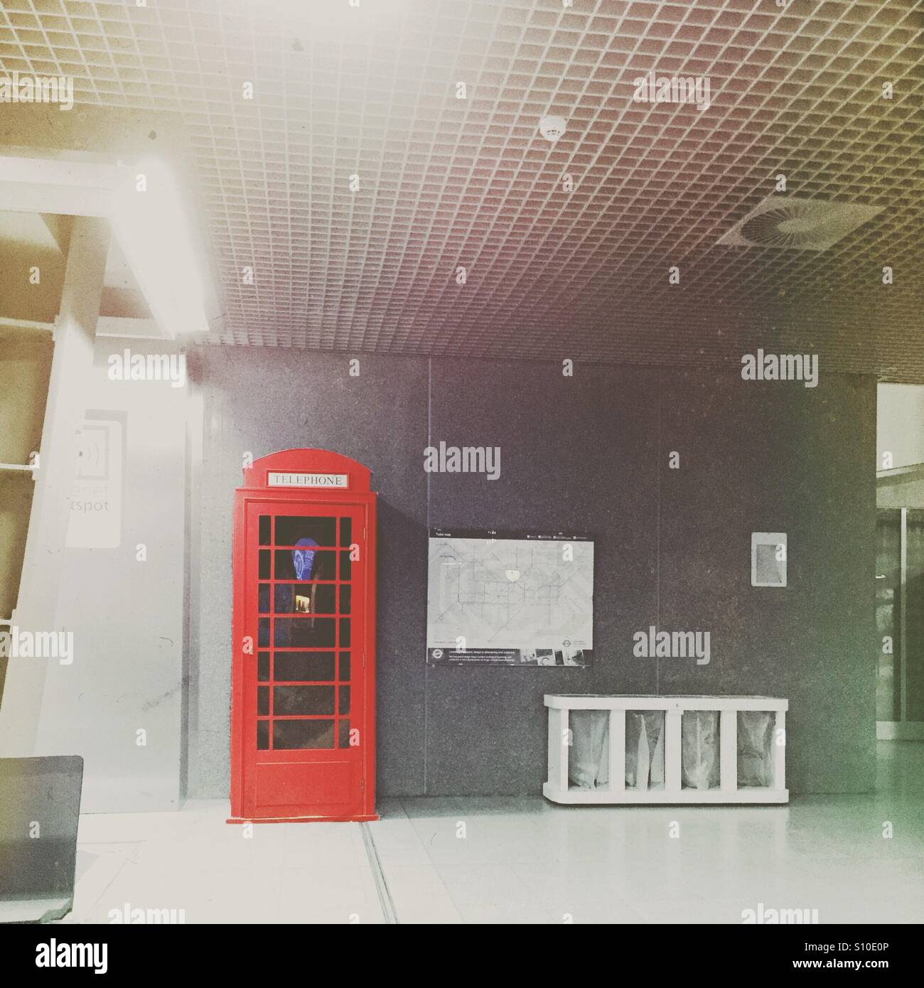 Lonely red phone box in Eurostar Brussels train station - Smartphone Captured Stock Image
