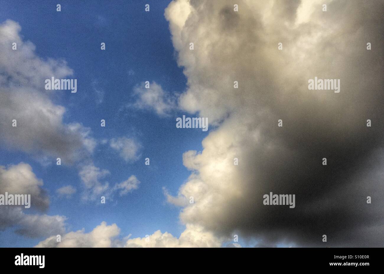 Blue sky with white and black clouds hi-res stock photography and ...