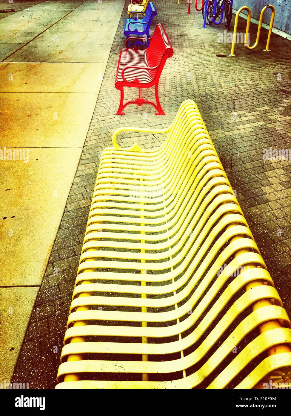 Perspective view of a row of colored benches Stock Photo