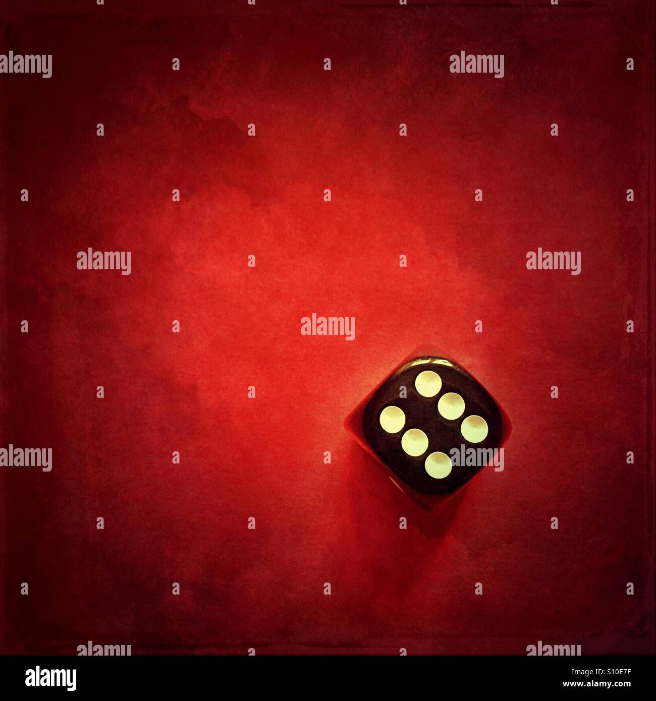 Dice on a red grungy background - Smartphone Captured Stock Image
