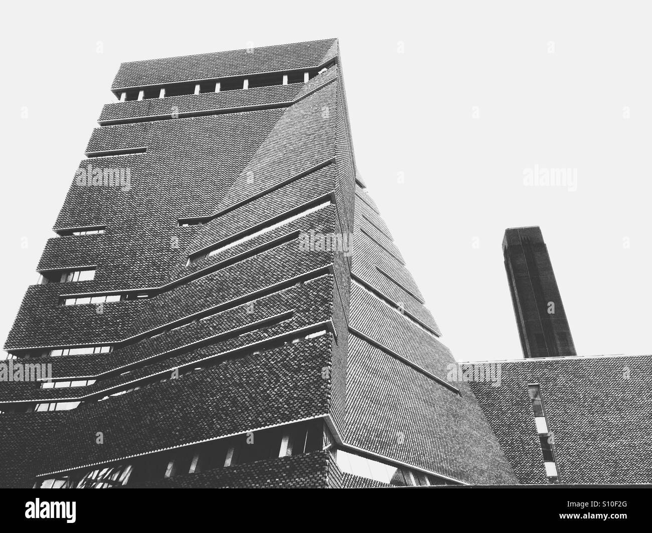 Black and white picture of the back of the new wing of Tate Modern with the current wing behind, Bankside, Southbank, London - Smartphone Captured Stock Image