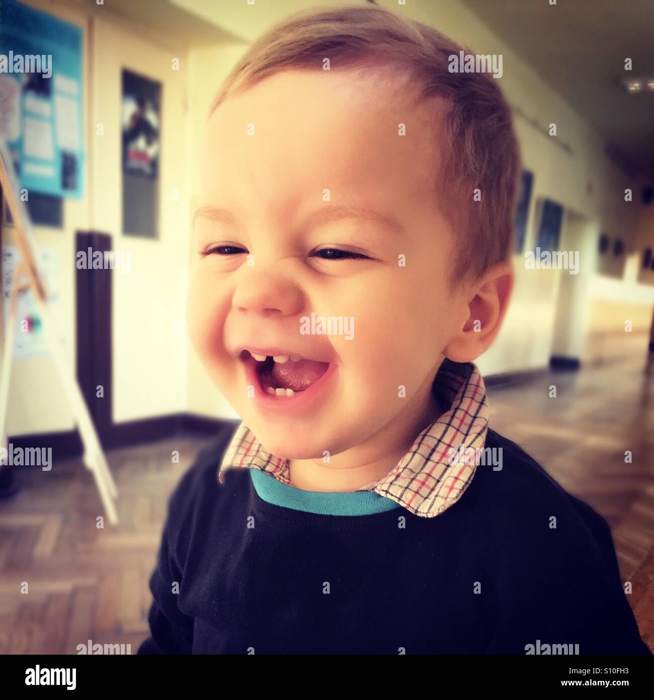 Happy baby boy laughing, having a great time in school Stock Photo