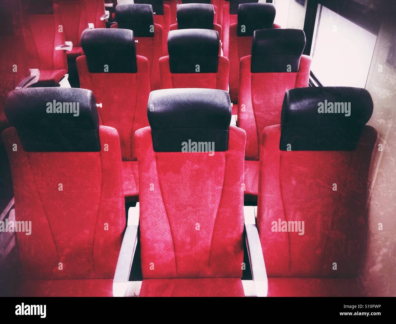 Rows of red seats inside a train - Smartphone Captured Stock Image