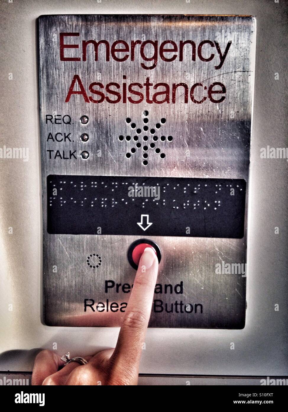Woman hand pushing emergency button - Smartphone Captured Stock Image