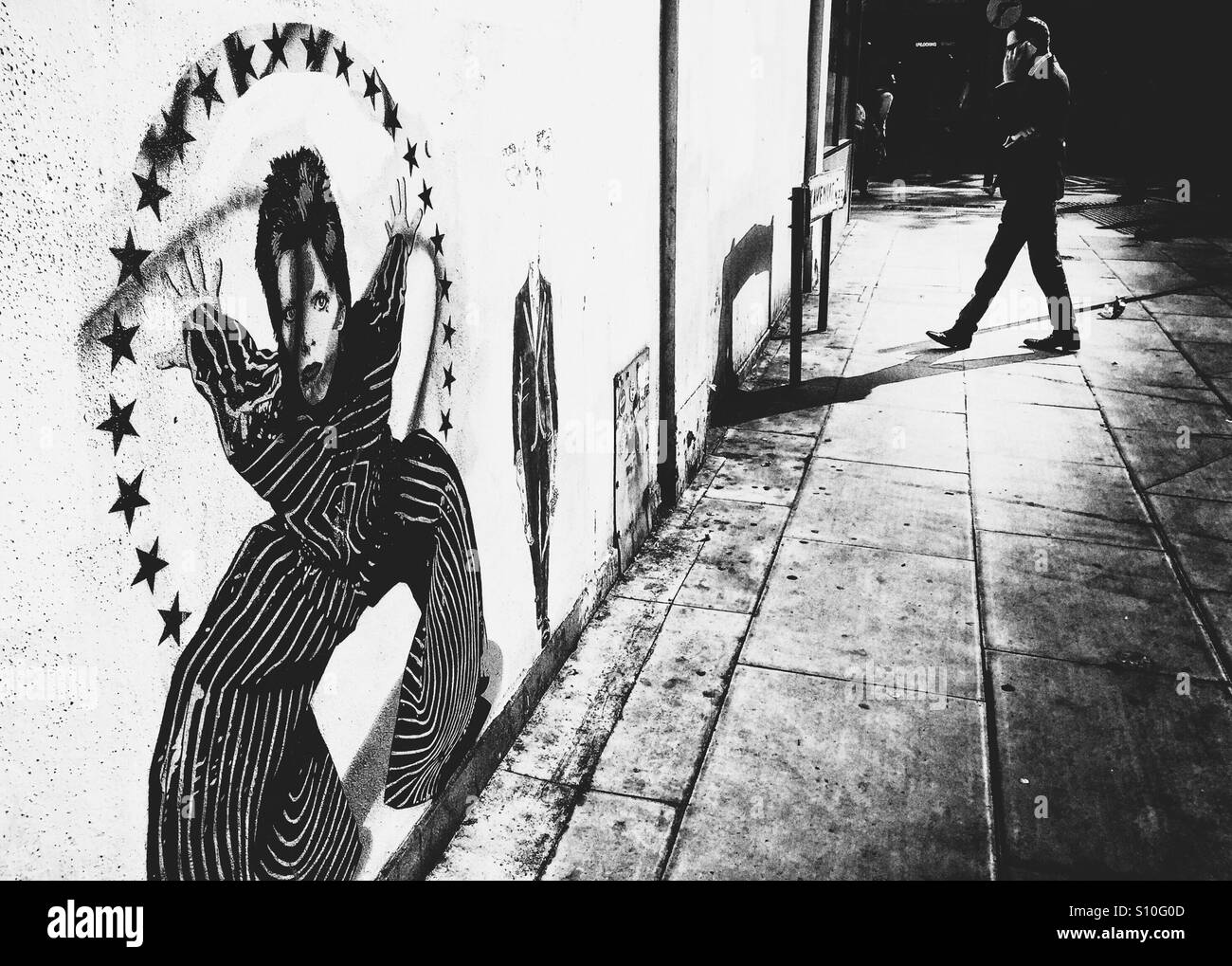 David Bowie mural. Man on mobile phone.Wood green shopping city. London. U.K. Stock Photo