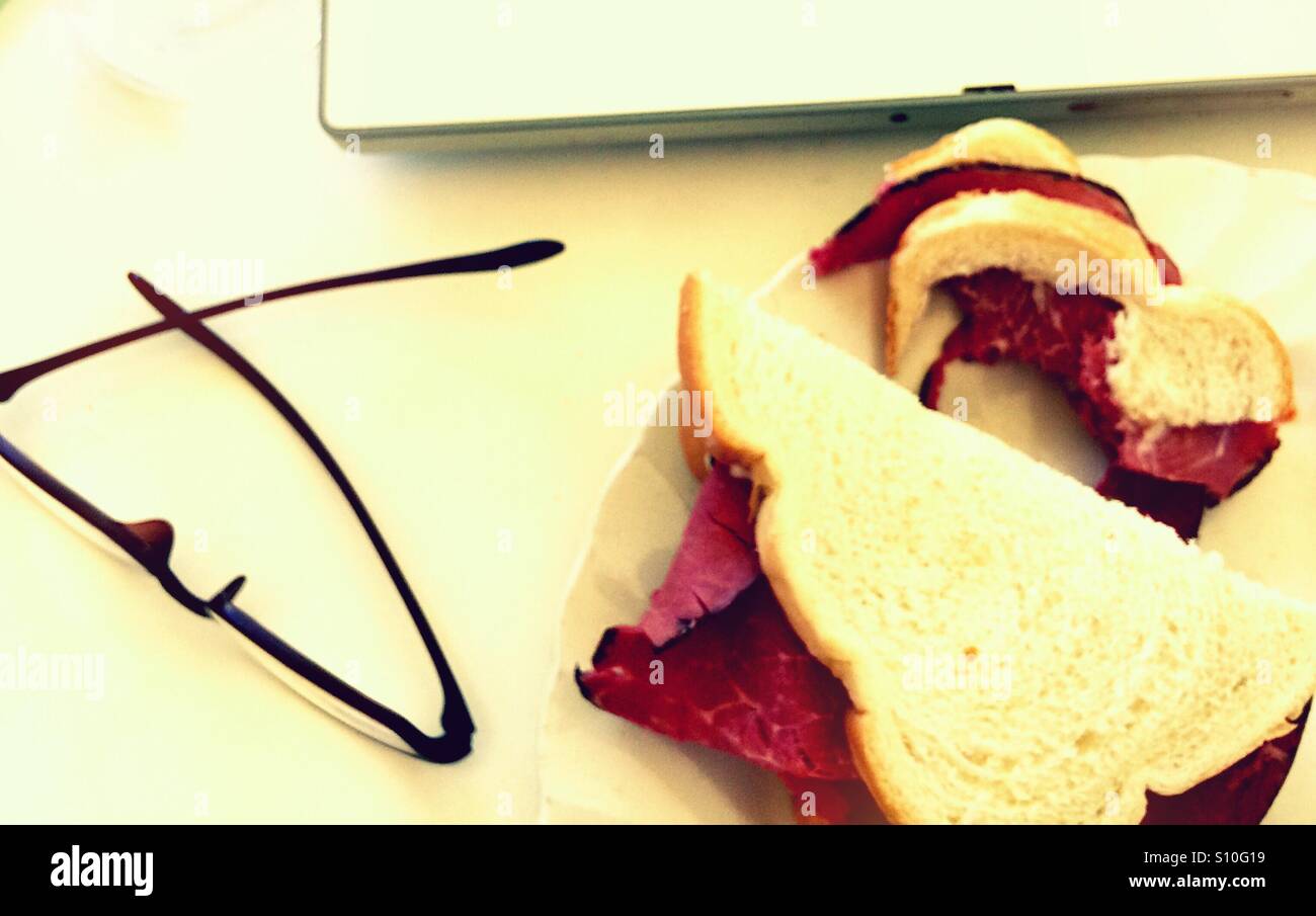 Half-eaten sandwich, laptop and glasses - Smartphone Captured Stock Image