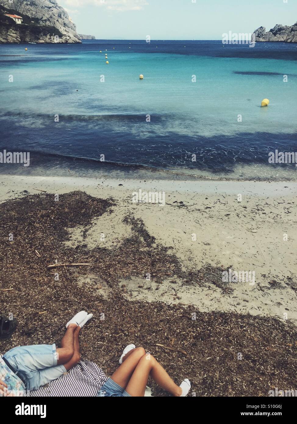Couple lying on the beach Les Calanques de Marseille France - Smartphone Captured Stock Image
