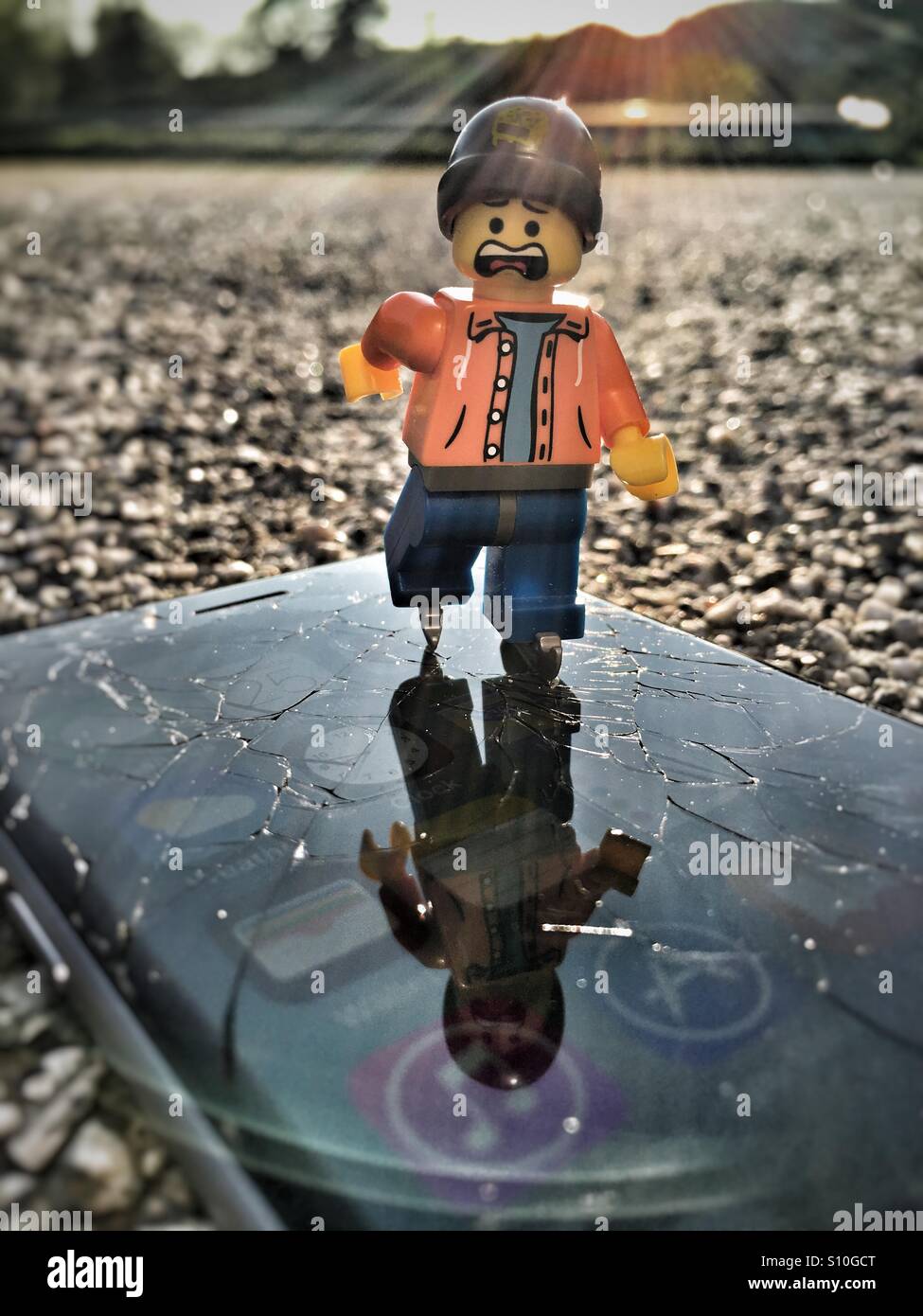 LEGO minifigure 'ice' skating on the broken glass of a phone Photo - Alamy
