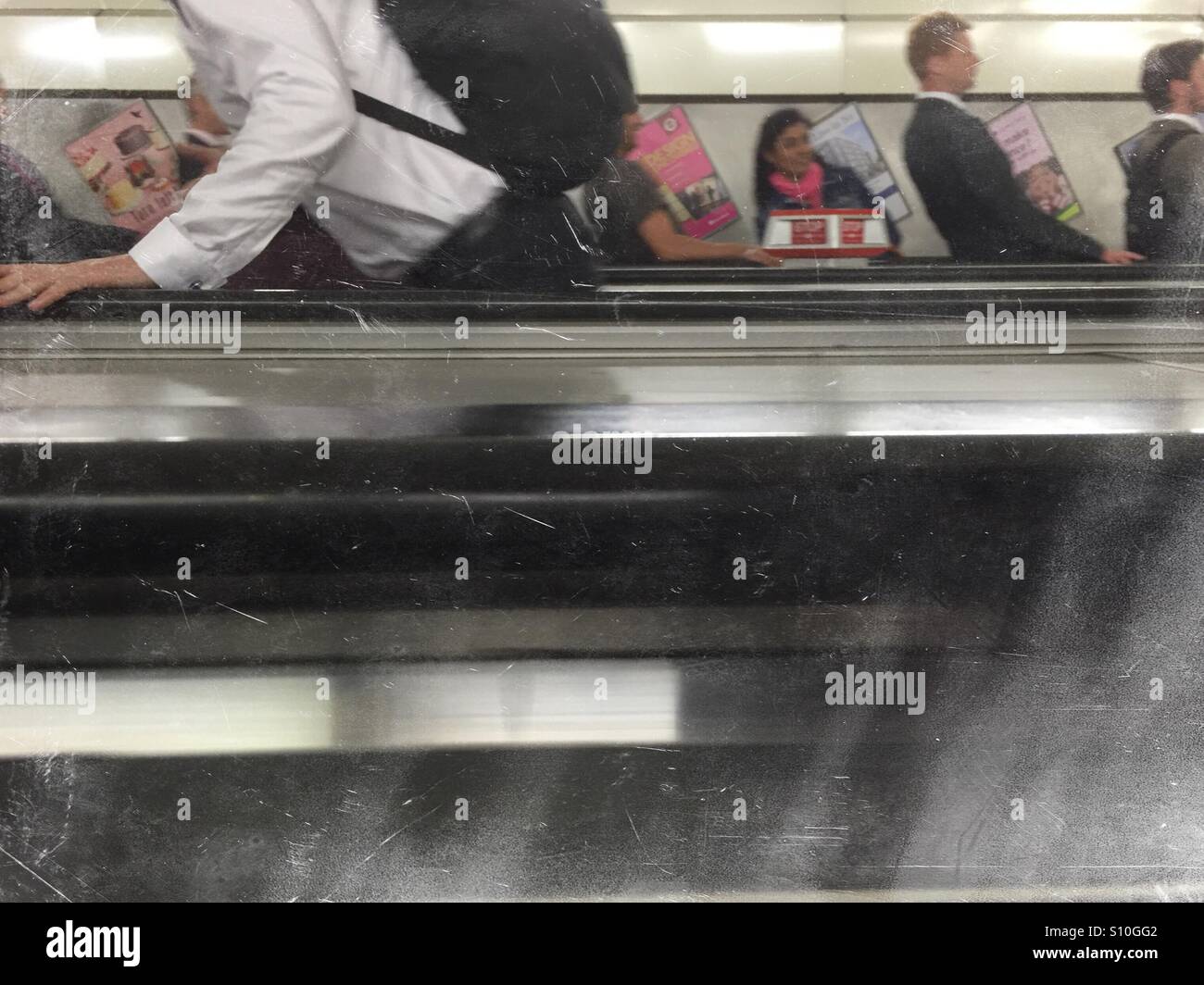 Commuters on mechanical stairs in London subway - Smartphone Captured Stock Image