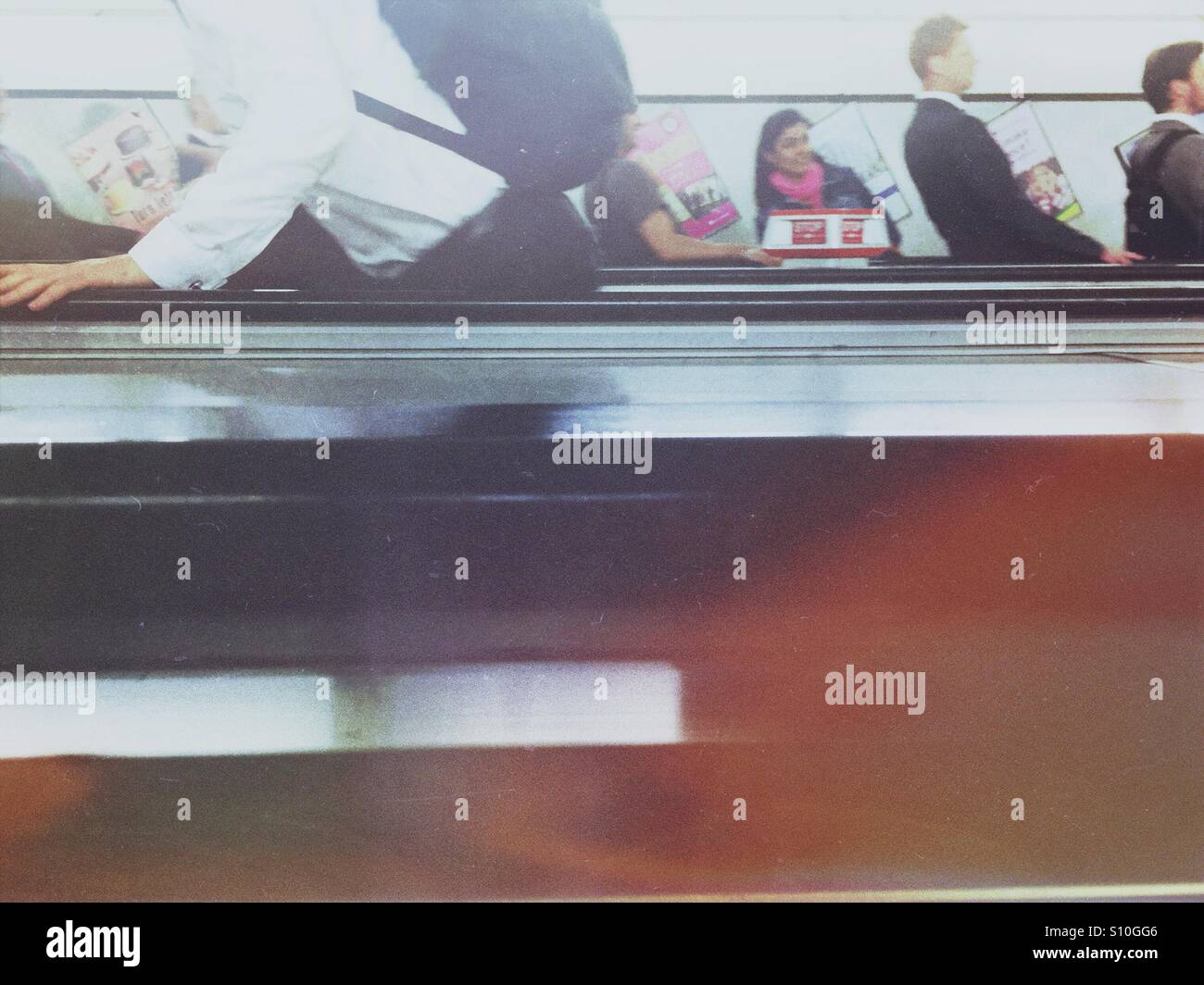 Commuters on mechanical stairs in London subway - Smartphone Captured Stock Image