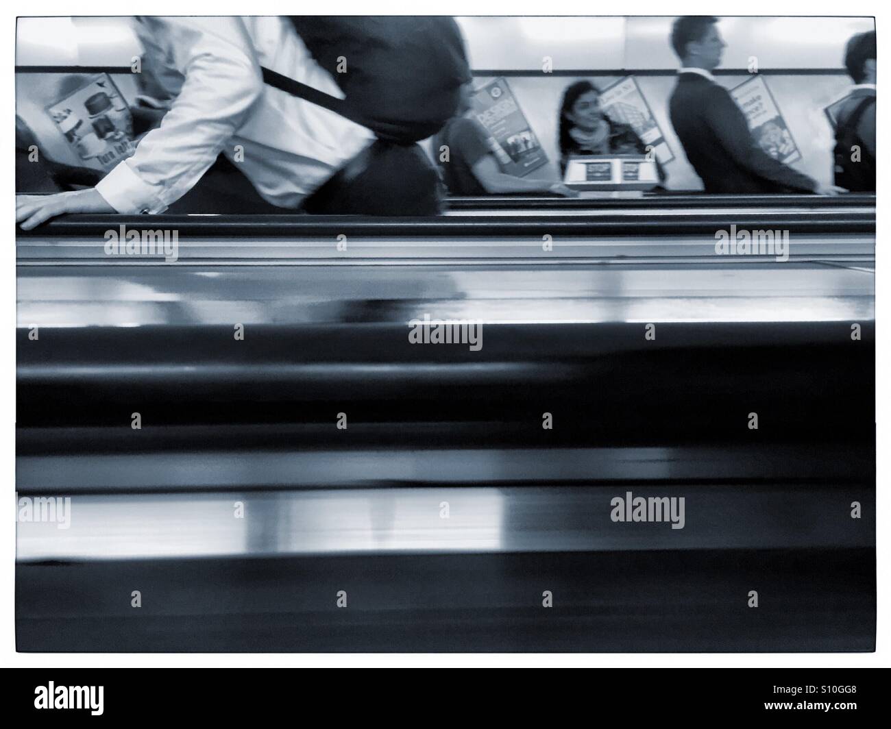 Commuters on mechanical stairs in London subway - Smartphone Captured Stock Image