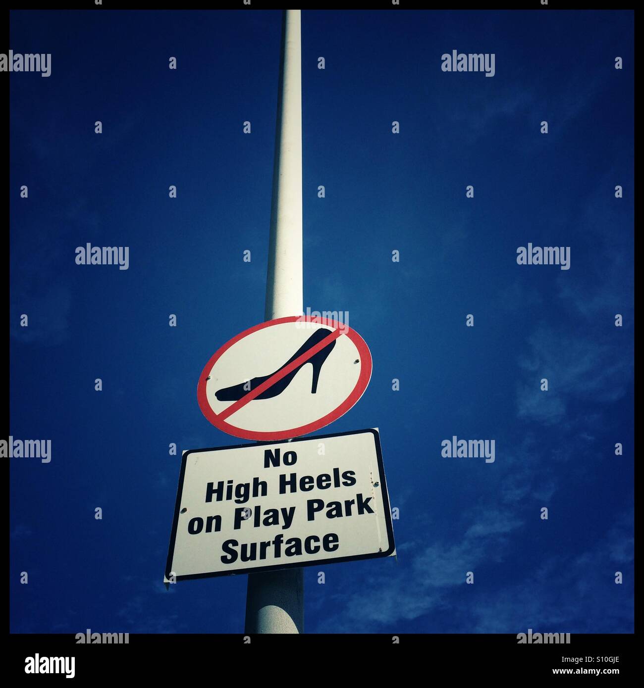 Sign at play park. No high heels on play park surface. - Smartphone Captured Stock Image