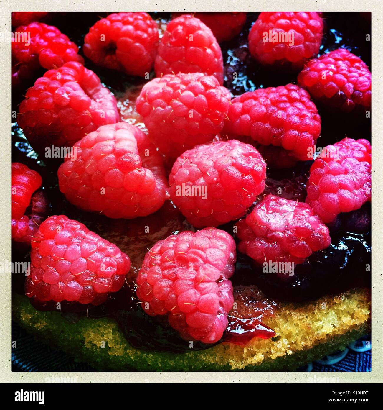 Raspberries, raspberry jam on sponge cake Stock Photo