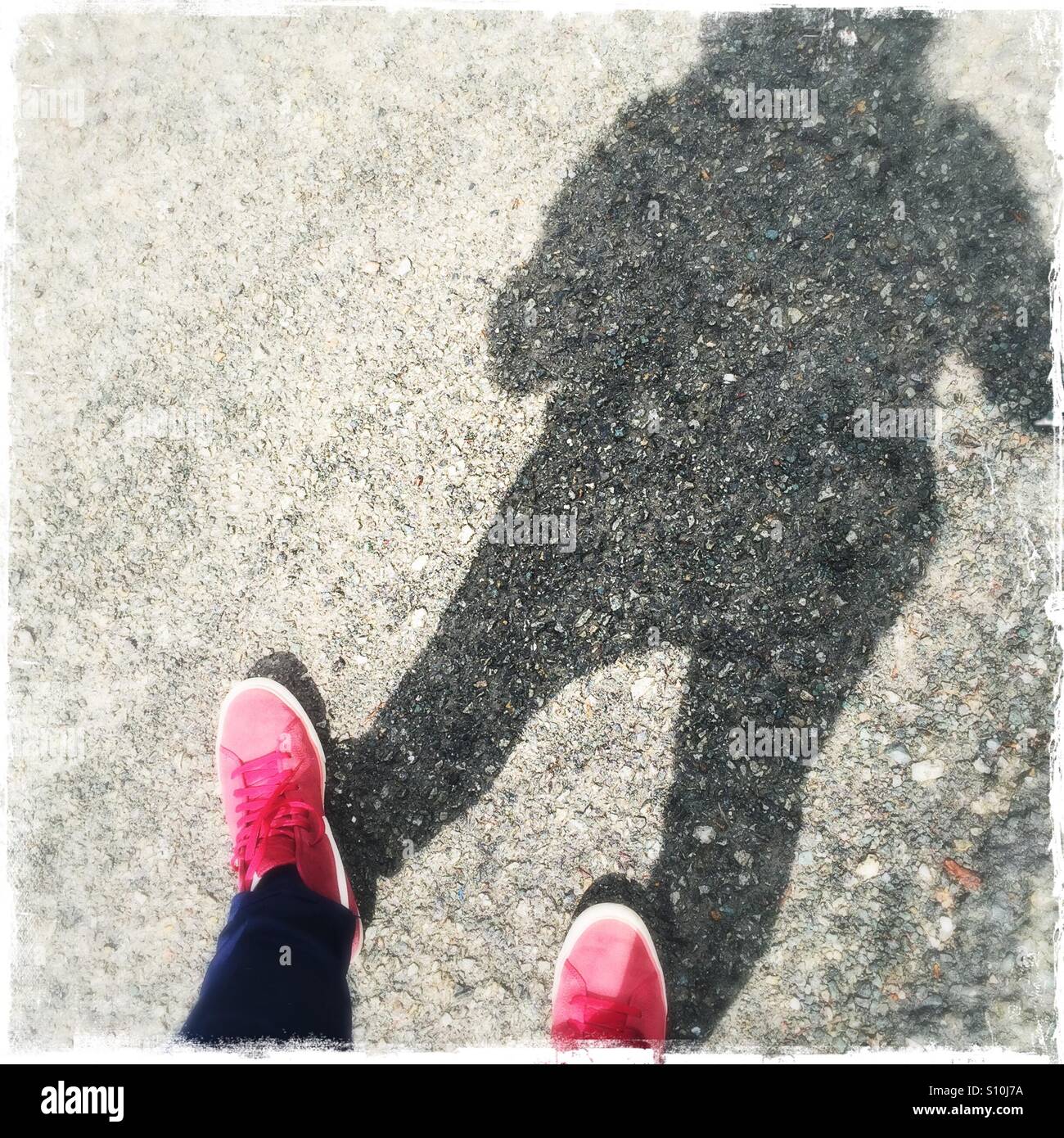 Red shoes with human shadow Stock Photo