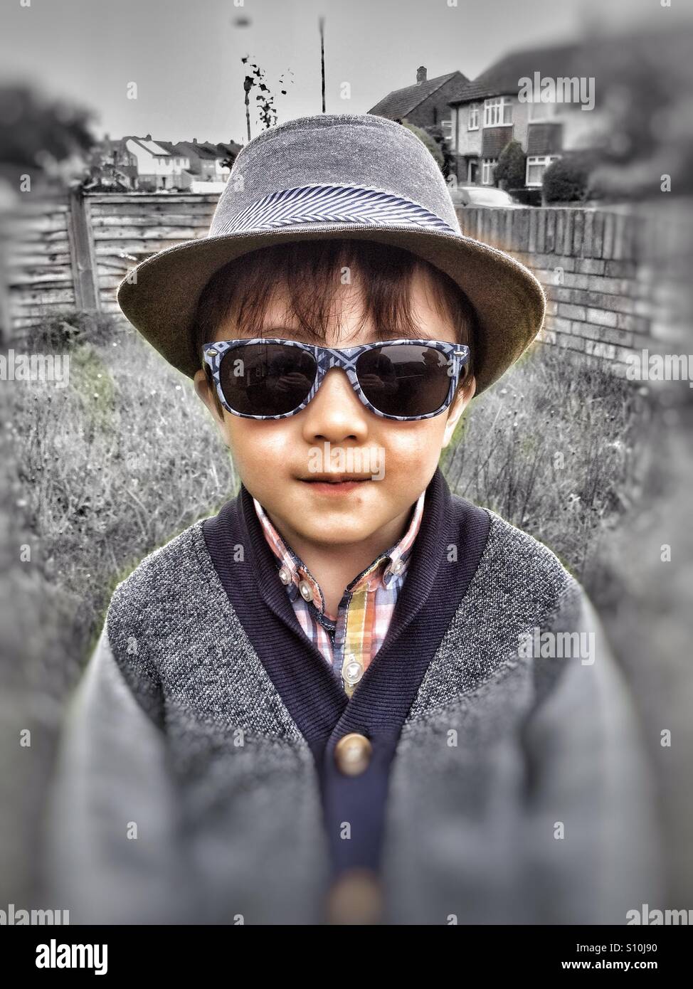 A young boy wearing a hat and sunglasses Stock Photo Alamy