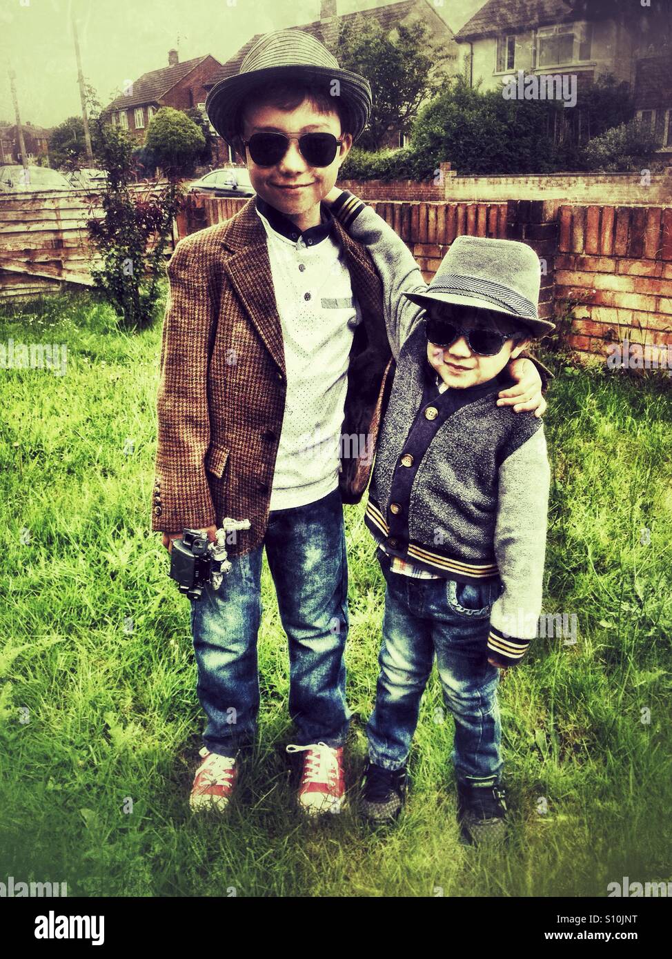Young brothers wearing hats and sunglasses. Stock Photo
