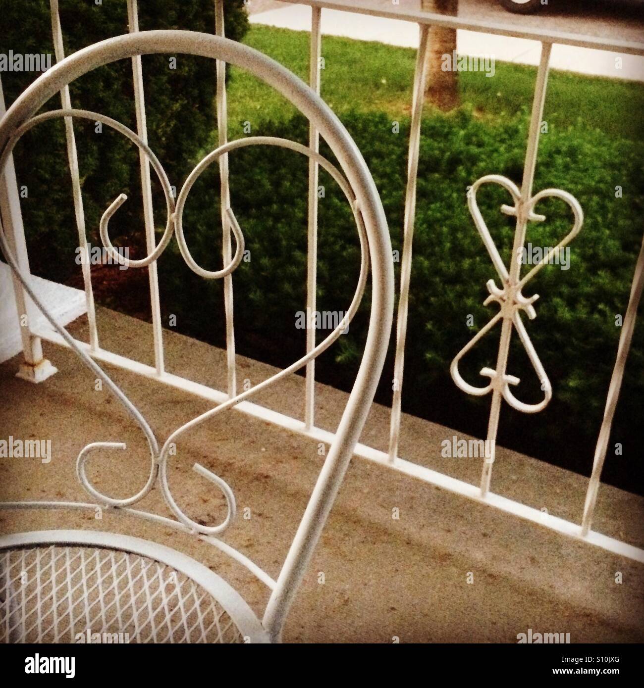 Matching wrought iron bistro table and chairs go with the railing
