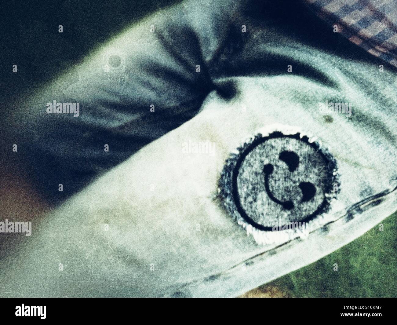 Smiley face patch on jeans. - Smartphone Captured Stock Image
