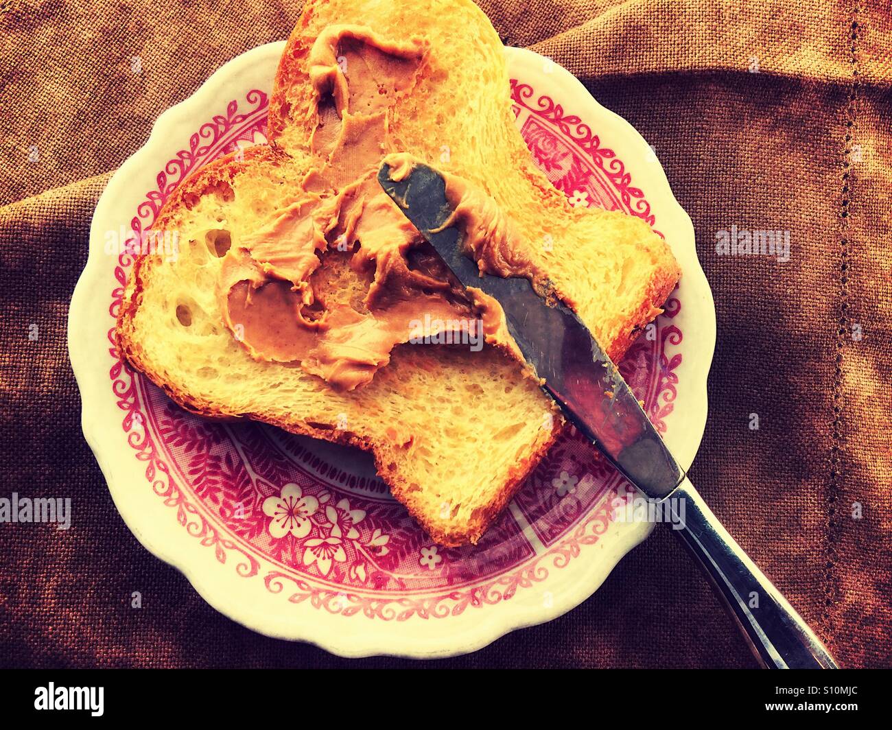 Spreading peanut butter on toast - Smartphone Captured Stock Image