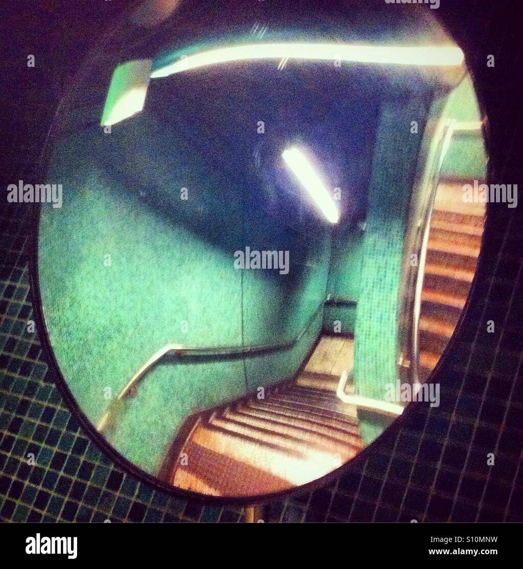 Round mirror in the stairs Stock Photo