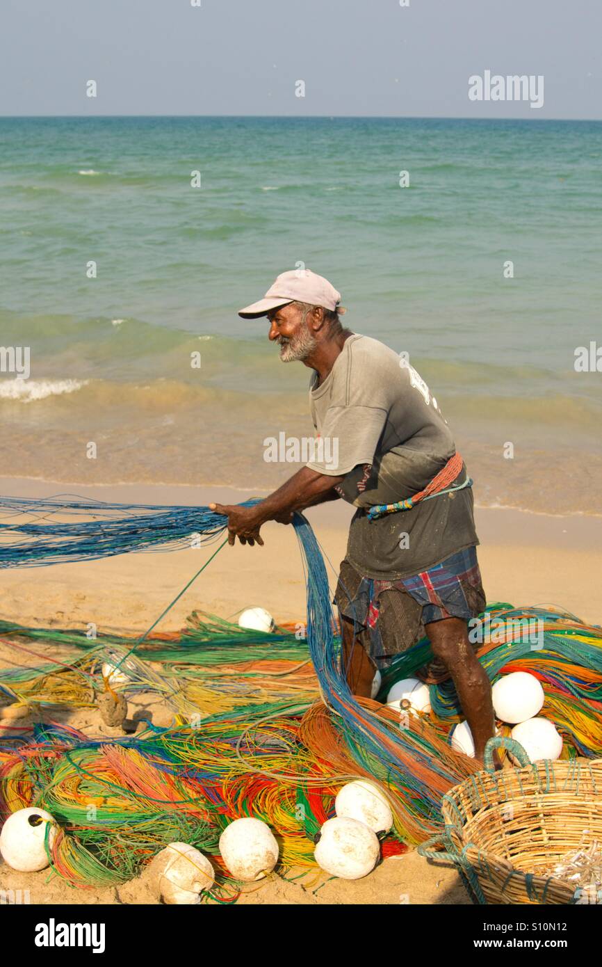Fisherman on the beach, Trincomalee, Sri Lanka - Smartphone Captured Stock Image