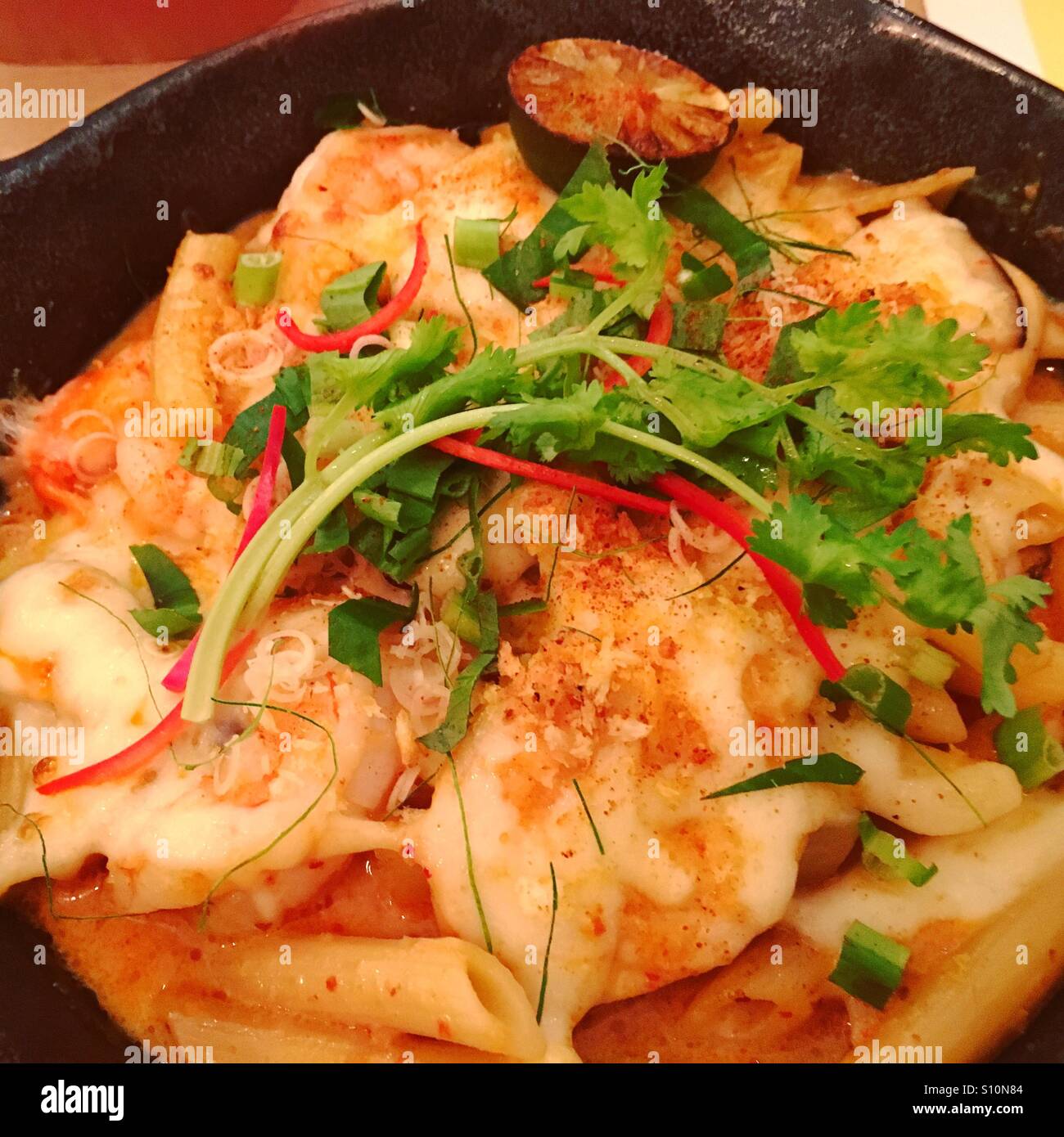 Tom Yum Kung Penne, spicy Thai fusion food Stock Photo