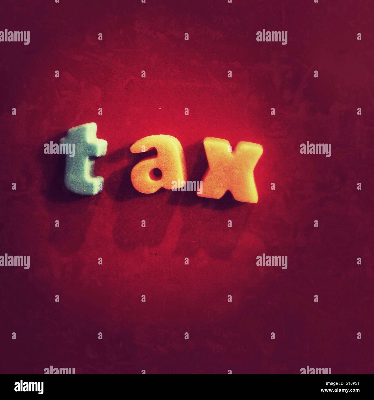 Tax written in magnetic letters - Smartphone Captured Stock Image