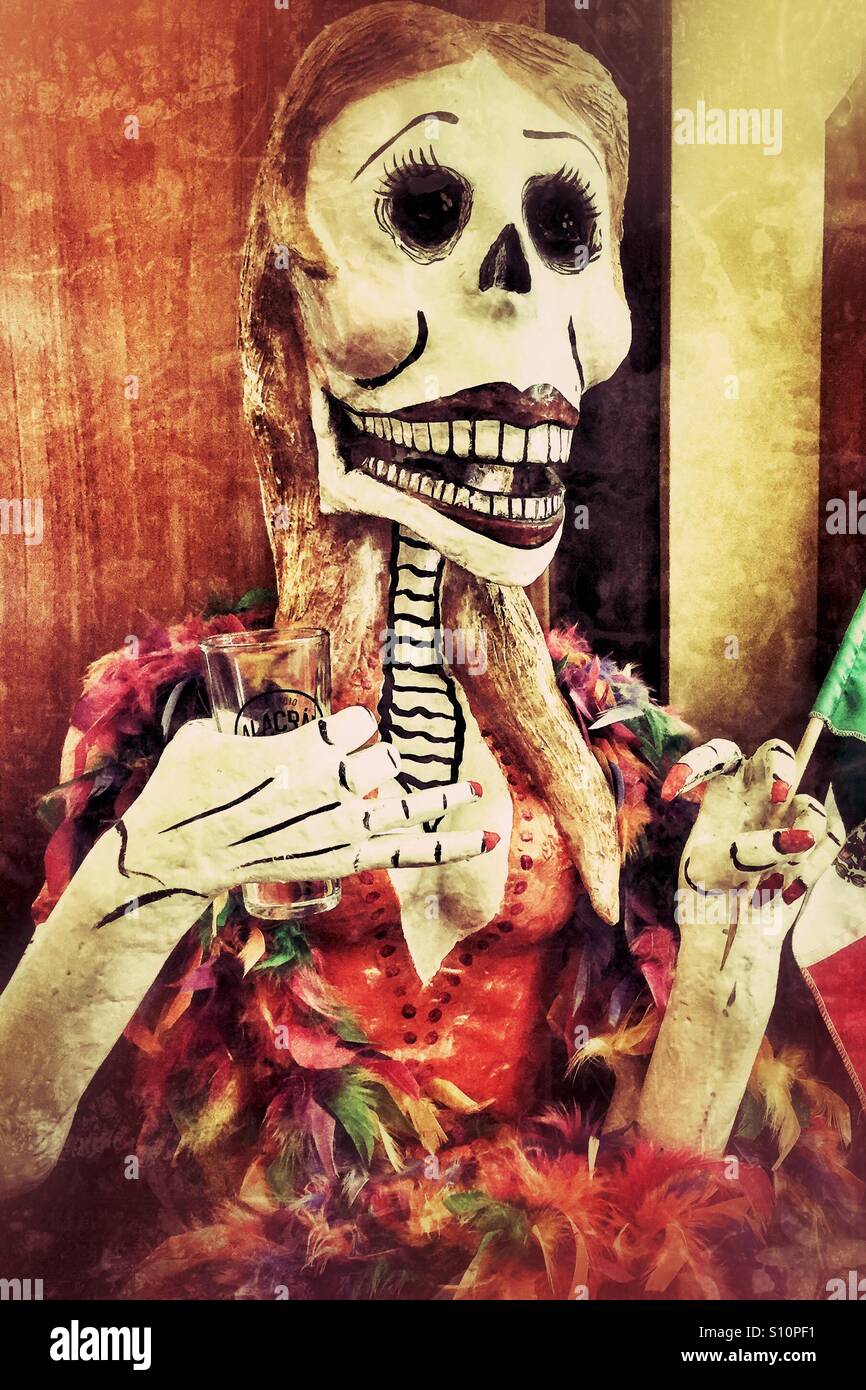 Female day of the day dead mannequin model holding a shot glass and Mexican flag with grunge filter - Smartphone Captured Stock Image