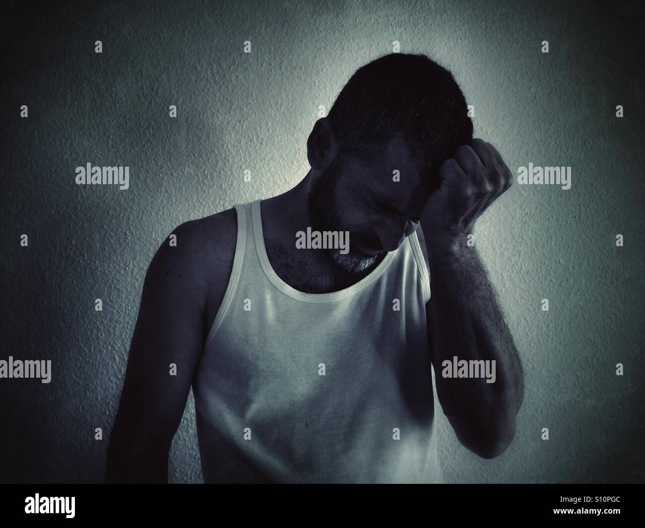 Depressed man head in hands - Smartphone Captured Stock Image