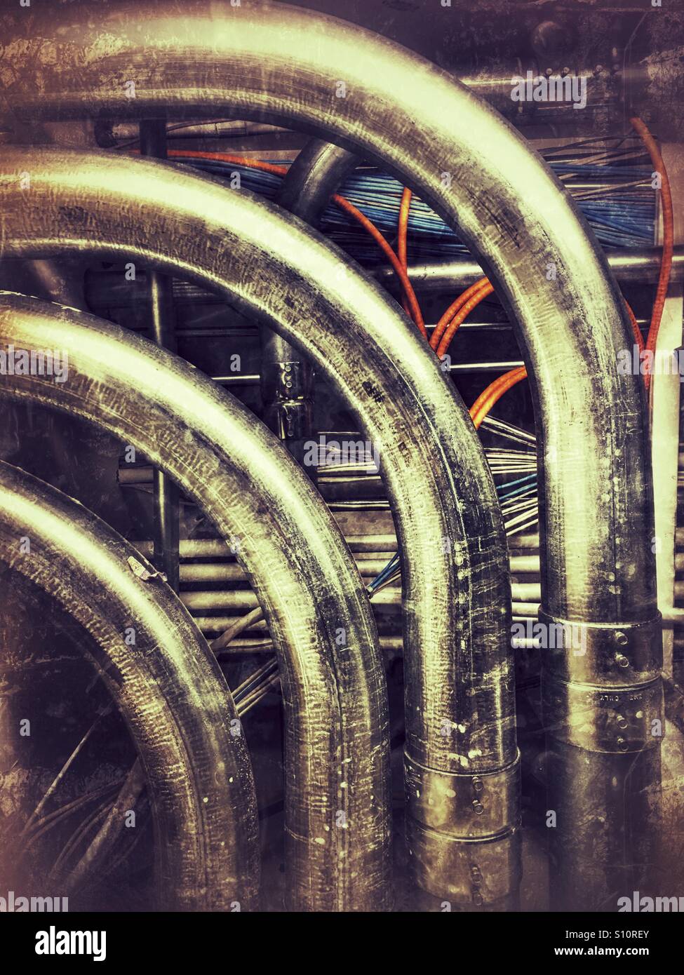 Maze of conduit and networking cables in a commercial building Stock Photo