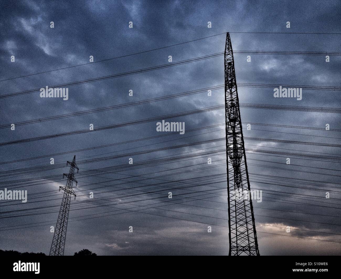Overhead high-voltage electricity cables running power from coal-Fired power stations in the Rhineland, Germany. - Smartphone Captured Stock Image