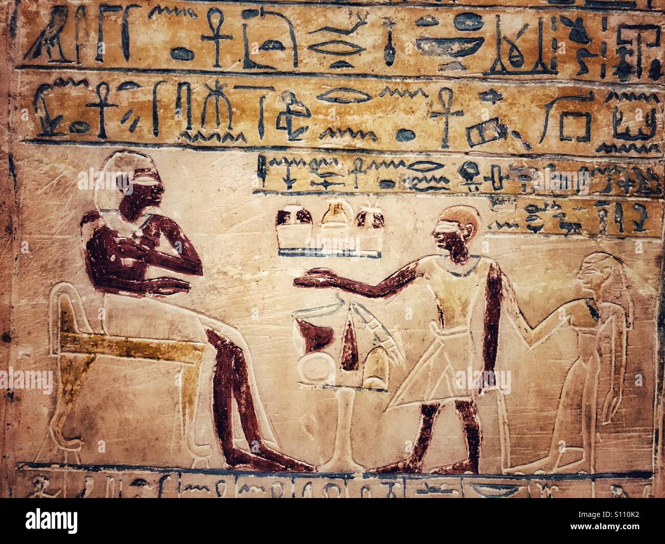 Ancient Egyptian wall paintings with figures and hieroglyphics. Stock Photo