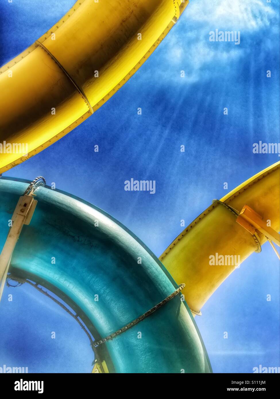 Abstract of colourful water chute rides against a blue sky - Smartphone Captured Stock Image