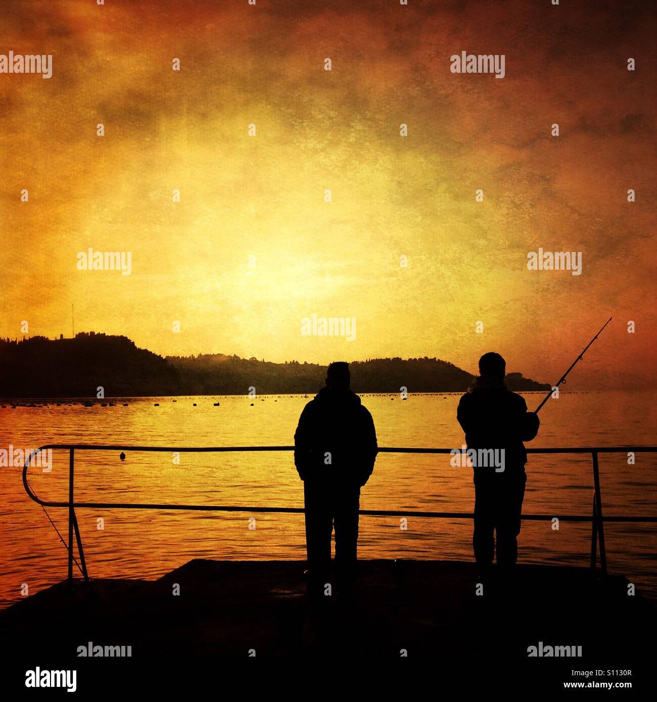Fishermen at the sunset Stock Photo - Alamy