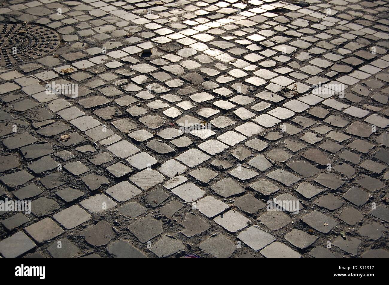 Beautiful sunset light on patterned cubic pavement - Smartphone Captured Stock Image