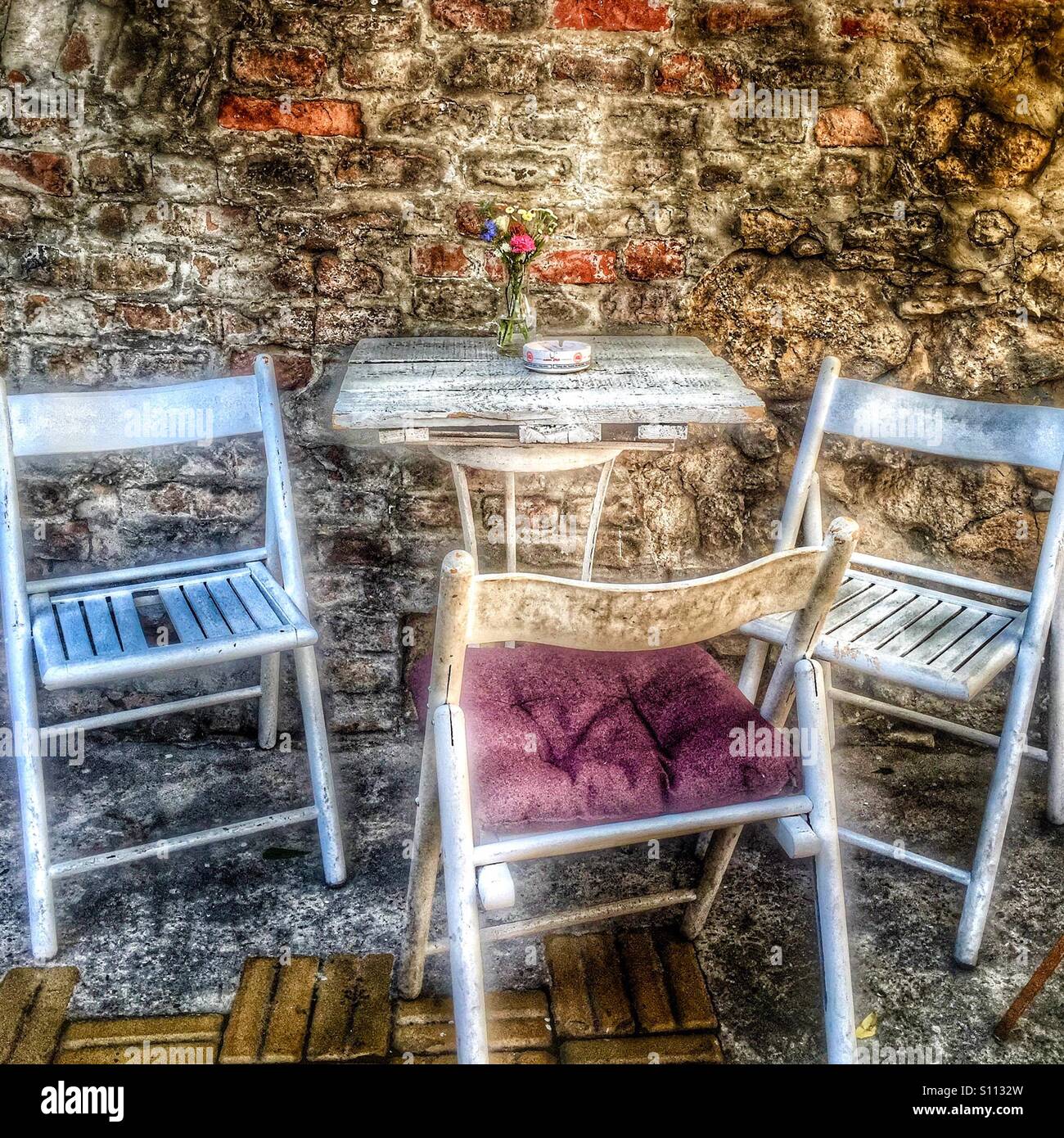 Table with chairs in a cafe garden Stock Photo